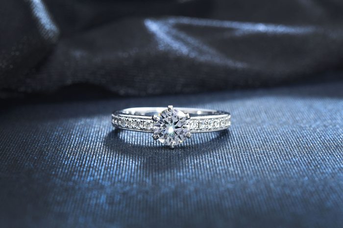 Diamond ring, engagement wedding ring on dark background.