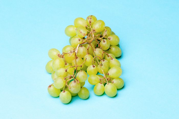 Green Grapes on a blue background