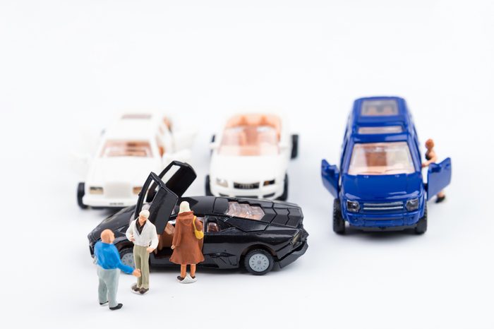 Nonthaburi, Thailand - August, 18, 2017 : Miniature man tiny toys agreed to buy a new car in the car showroom.Happy life background.selective focus