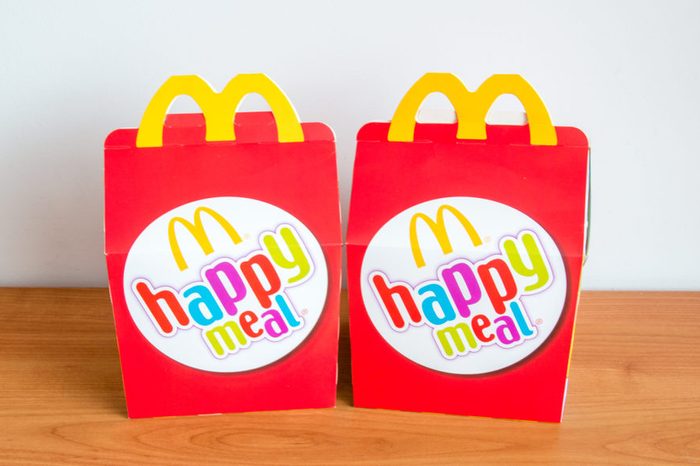 Pruszcz Gdanski, Poland - February 22, 2018: McDonald's happy meal's boxes on wooden table.
