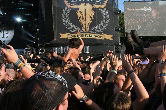 SCHLESWIG-HOLSTEIN, GERMANY - JULY 31: Crowd of people and stage diving at Wacken Open Air, world's largest open air heavy metal music festival on July 31, 2009, in Schleswig-Holstein, Germany