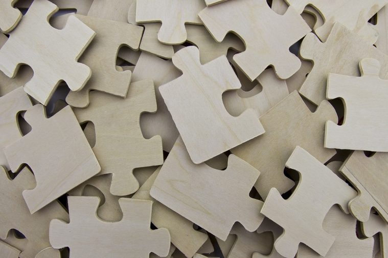 Scattered wooden puzzle pieces