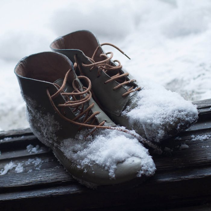 shutterstock_571822381 winter snow boots in entryway