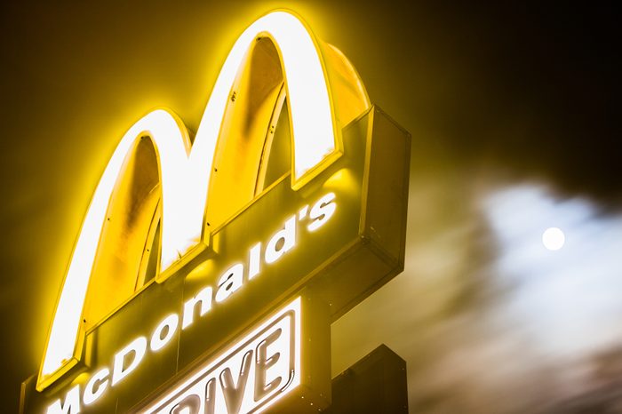 Lodz, Poland, January 1, 2018 yellow McDonald's sign, night, clouds, moon in background, McDonald's was founded in 1940 as restaurant operated by Richard and Maurice McDonald, in San Bernardino, USA