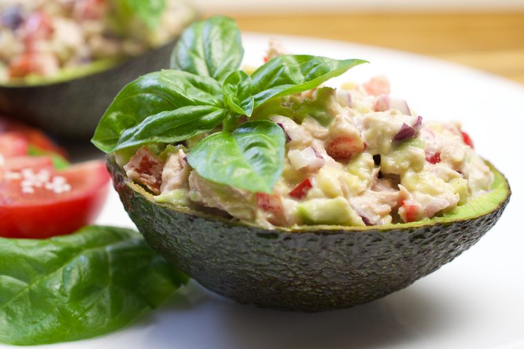 Tuna stuffed avocado. Avocado tuna salad. Healthy lunch - tuna stuffed avocado. Tuna salad