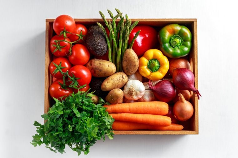 Fresh Vegetables in wooden box on white wooden background