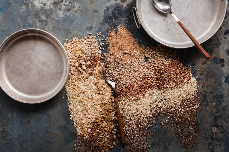 Multi grain porridge barley grains, amarants grains golden millet raw cereals granola muesli vegan breakfast concept 