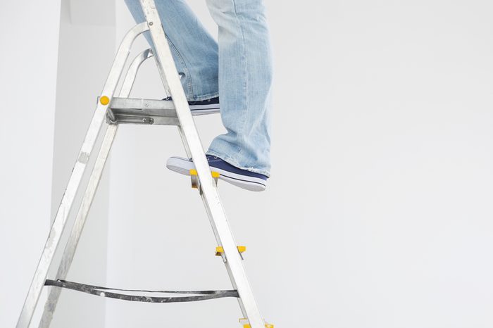 Low section of man on ladder