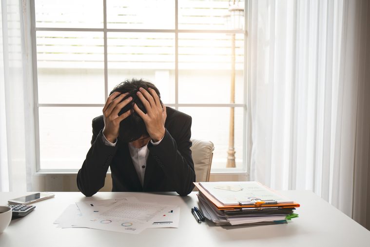 Menopausal men are suffering from headaches and migraines after working hard on accounting documents.