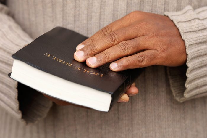 Man holding a Bible in his hands.