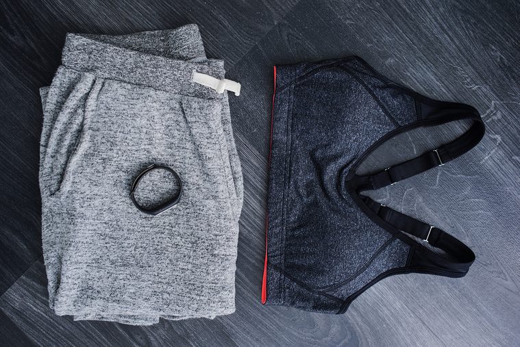 Gym outfit - workout clothing in gray colors. Matching clothes, sports bra.