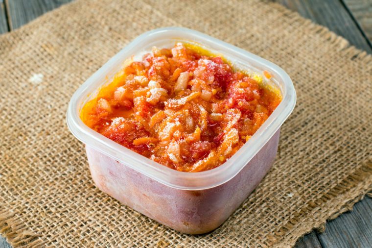 Frozen tomato sauce in a container