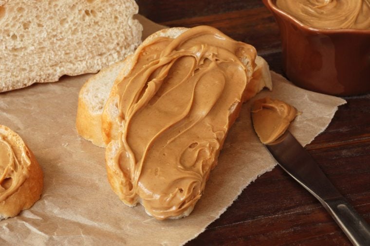 peanut butter on bread with knife