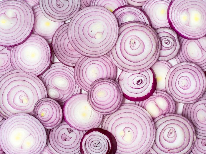 Background photo of sliced red onions.