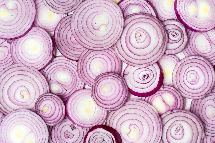 Background photo of sliced red onions.
