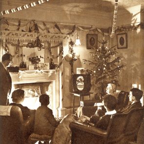 Mandatory Credit: Photo by Historia/Shutterstock (9831785a) A 1950s Family Sit Around the Fire at Christmas Time Listening to A Wireless Broadcast Streamers and Paper Chains Hang From the Ceiling and A Rather Mean Looking Christmas Tree Stands in the Corner. . Photograph by Sketch Special Photographer, Harold White, the Sketch, 31 December 1952 Christmas 1952 by Harold White, 1952