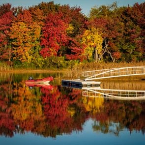 Dinghy on lake with fall foliage near Kennebunkport, Maine in autumn