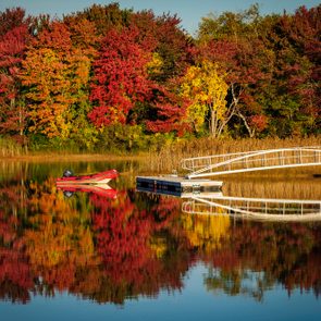 Dinghy on lake with fall foliage near Kennebunkport, Maine in autumn