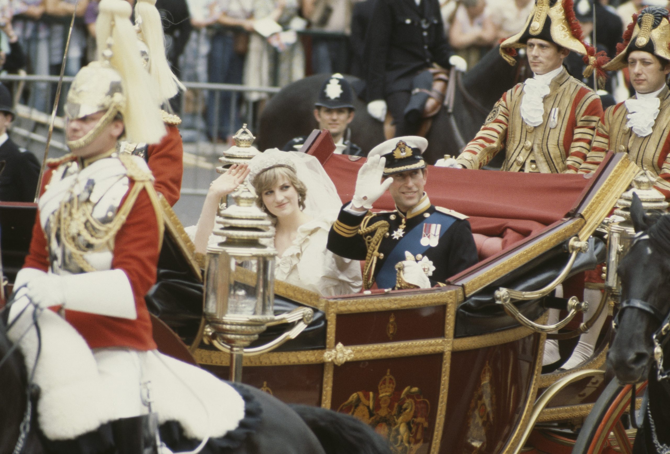 Charles, Prince of Wales, and his wife, Princess Diana (1961 - 1997), wave to the crowds following their wedding ceremony