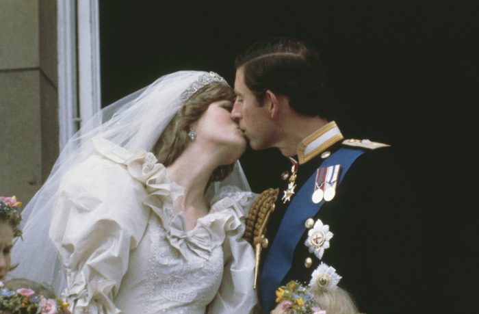 Prince Charles, Prince of Wales, kissing his wife, Princess Diana (1961 - 1997), on the balcony of Buckingham Palace in London after their wedding