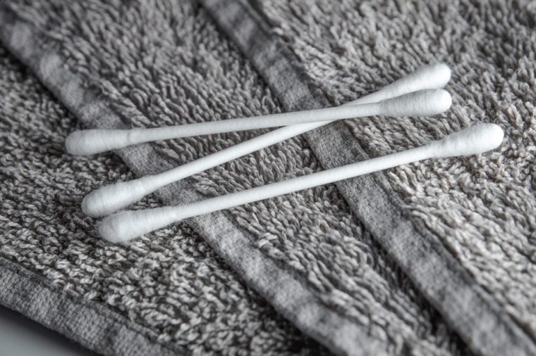 white q-tips on grey terry towel