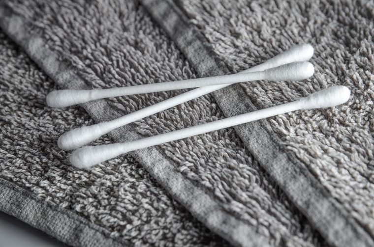 white q-tips on grey terry towel