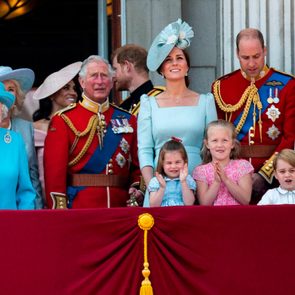 the royal family standing together outside of the palace
