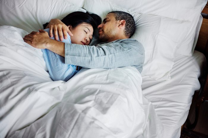 Couple hugging on a bed