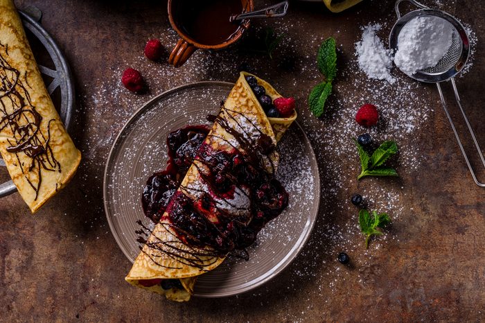 Delicious crepes with forest fruit, topped and filled with forest fruit, mint and dark chocolate, delicious breakfast