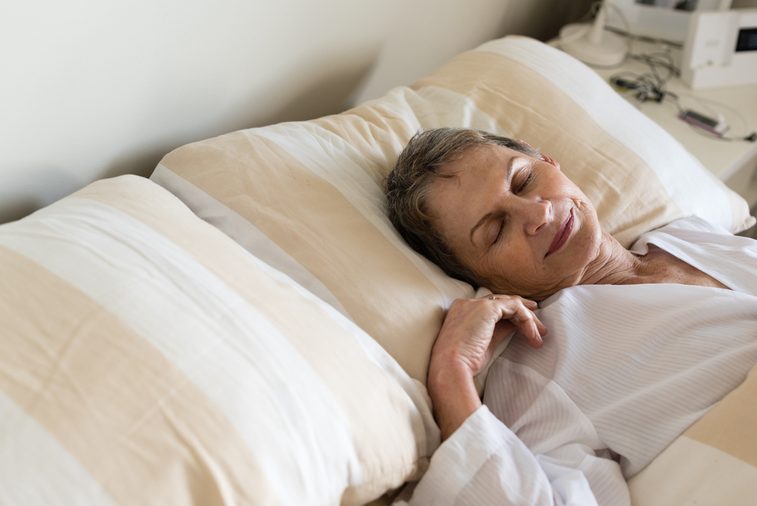 HIgh angle cropped view of elderly woman sleeping in bed (selective focus)