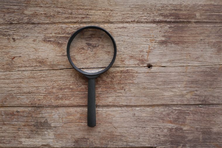 magnifying glass on wood background