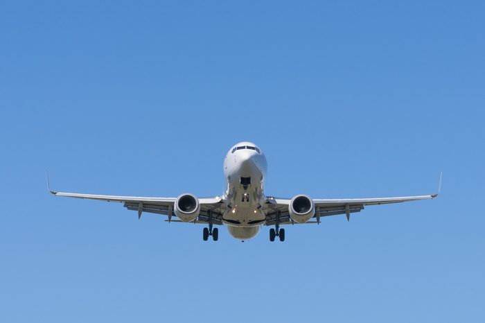 Front view of a jet passenger airplane approaching an airport for landing