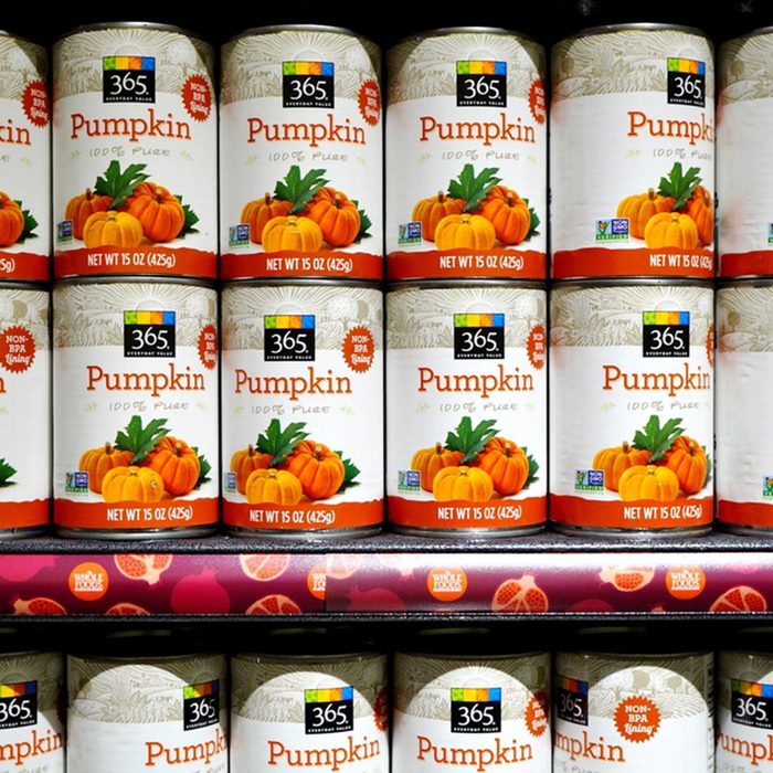 Cans of pumpkin puree lined up on the shelf from 365, the low cost brand of Whole Foods Market.