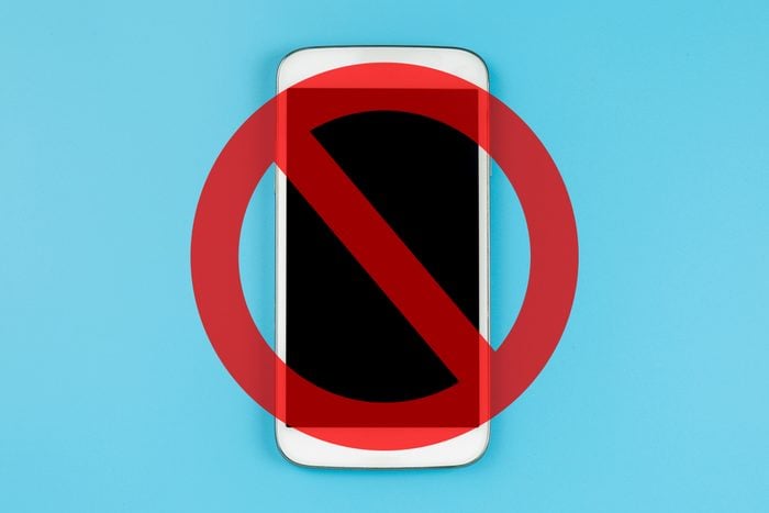 personal cell phone on blue background with a cancel sign over it