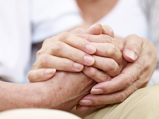 close-up of hands of a senior couple held together, concept for love, help, comforting and consoling