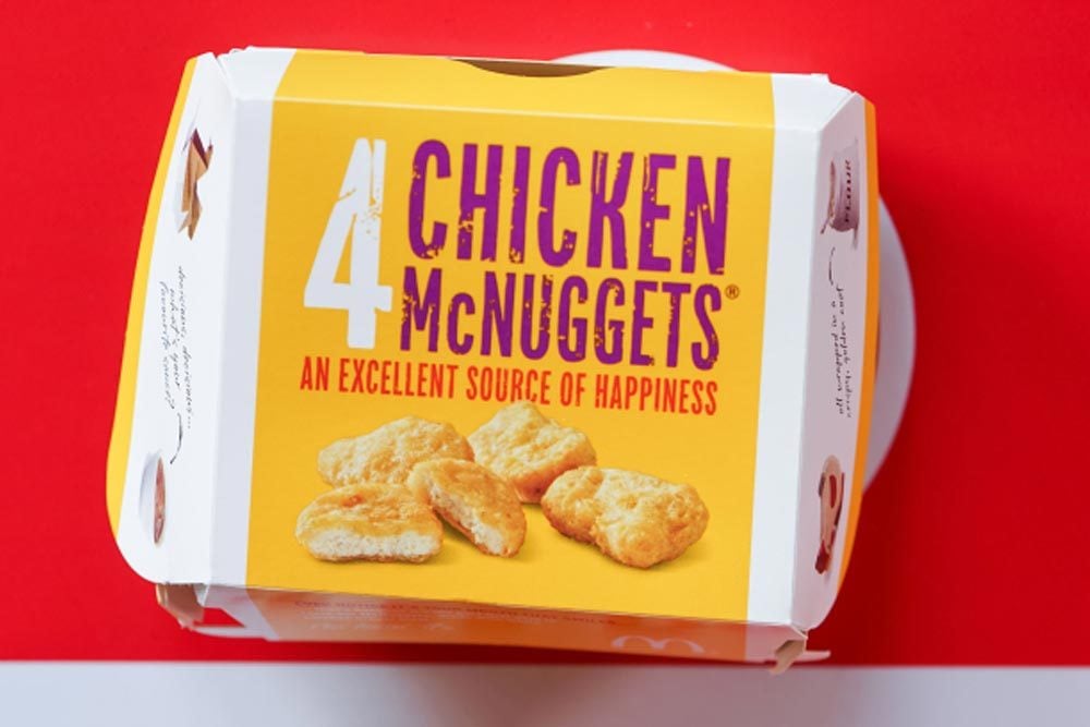 BANGKOK,THAILAND - MARCH 10,2018 : top view of Mc NUGGETS on brown desk with phrase For McDonald's Customer & Food Only