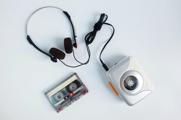 Retro cassette tape and Portable tape player with radio on white floor, top view