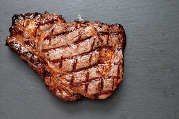 ethically raised, fresh cut organic rib eye steak grilled rare