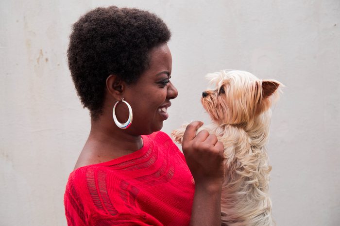 black woman holding a yorkshire dog