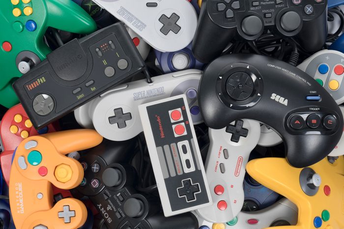 Taipei, Taiwan - February 19, 2018: A pile of retro video game controllers shot from above.