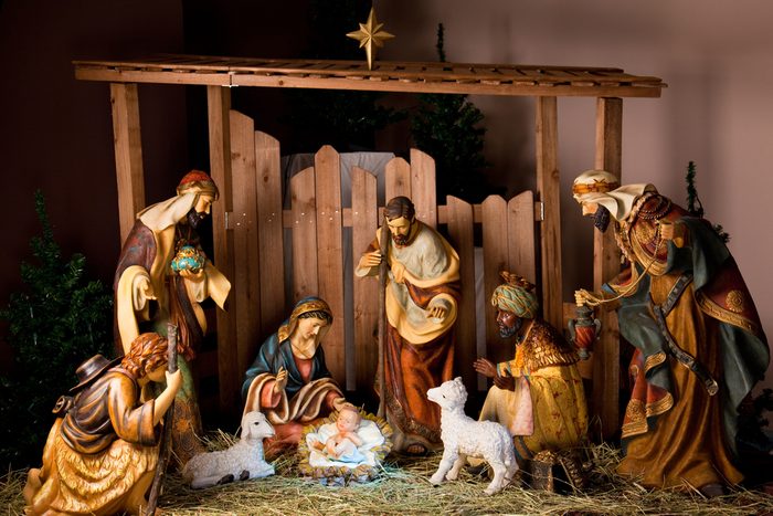 Christmas Manger scene with figurines including Jesus, Mary, Joseph, sheep and magi.