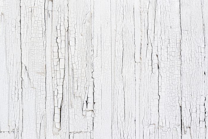 Close Up of Chipped White Paint on an Exterior Wood Wall