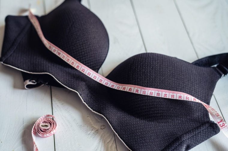 Women underwear bra and tape measure, breast loss concept, measuring bust