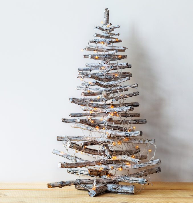 Christmas tree made of wooden branches with copy space