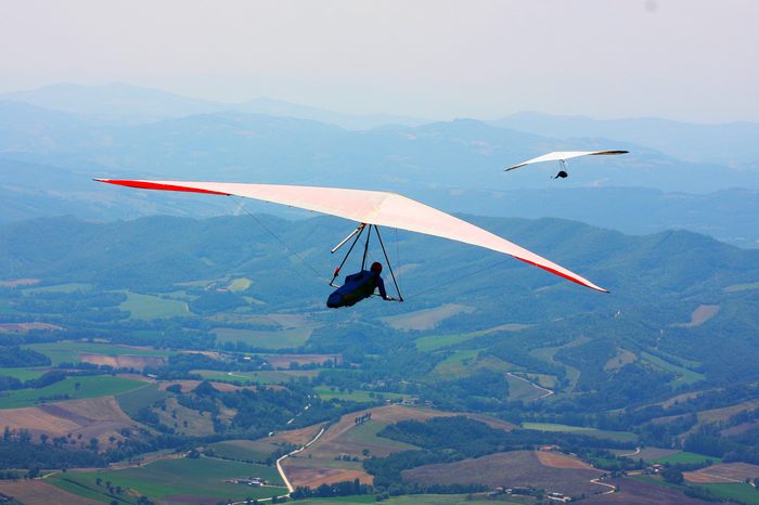 Hang glider flying in the Italian mountains