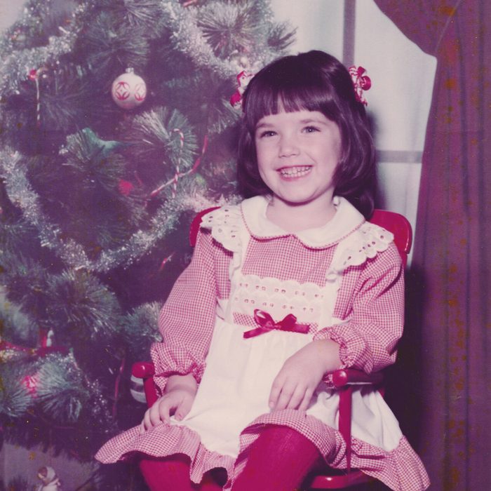 Girl posing for a picture in a red Christmas dress