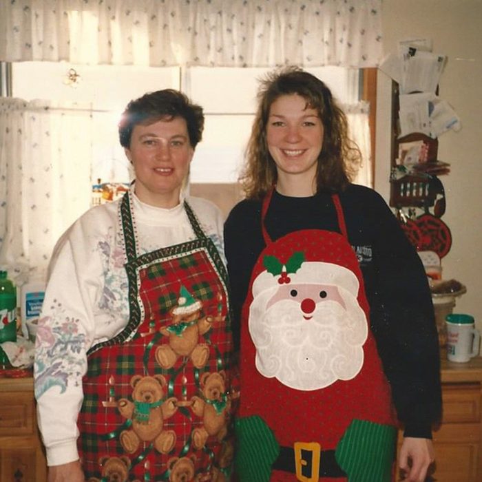 Mother and daughter get ready to bake together in their festive aprons
