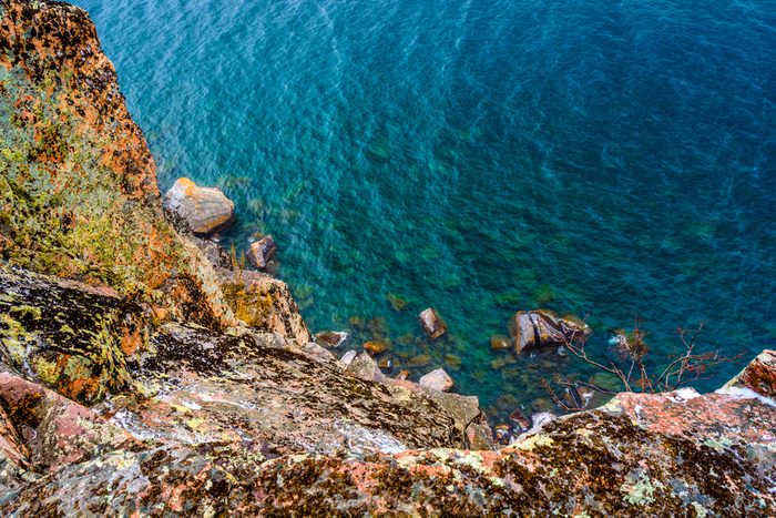 A view looking down the cliff into the beautiful waters of Lake Superior from the Palisade Head Cliffs on the North Shore in Minnesota. 