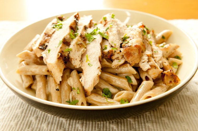sliced grilled chicken and creamy herbed sauce over penne pasta