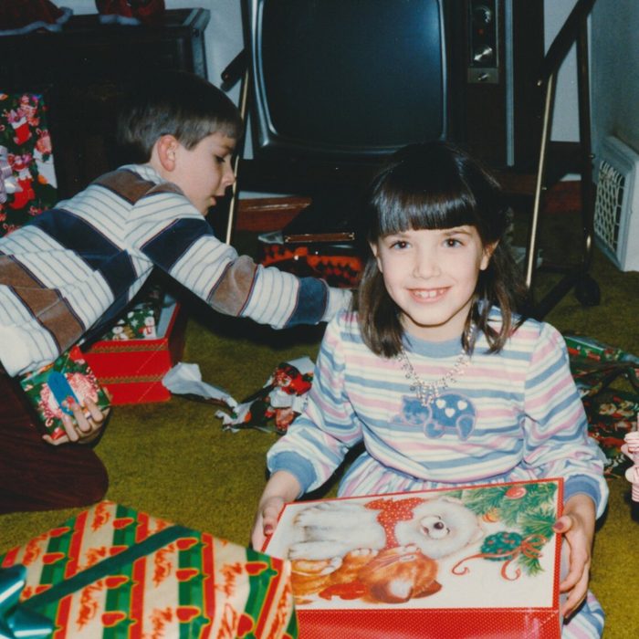 Boy and a girl opening a sea of Christmas presents